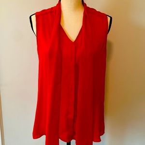 Red sleevless blouse, button down with front neck ties.